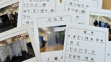 Seven sheets of white paper are scattered across a wood table. Social stories and pictures of opera sets are printed on the papers.
