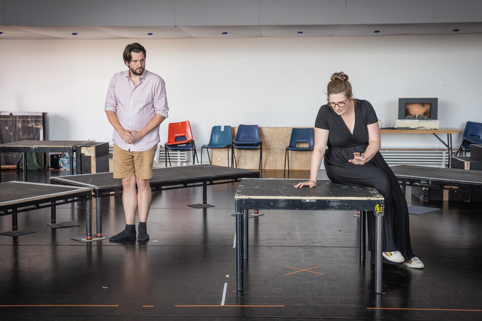 A man and woman singing in the rehearsal room