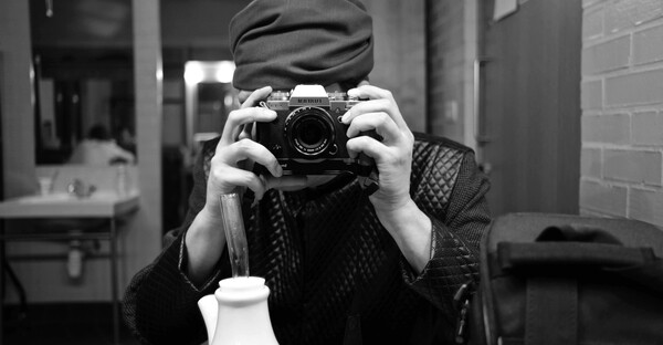 Singer taking picture of themselves in a mirror