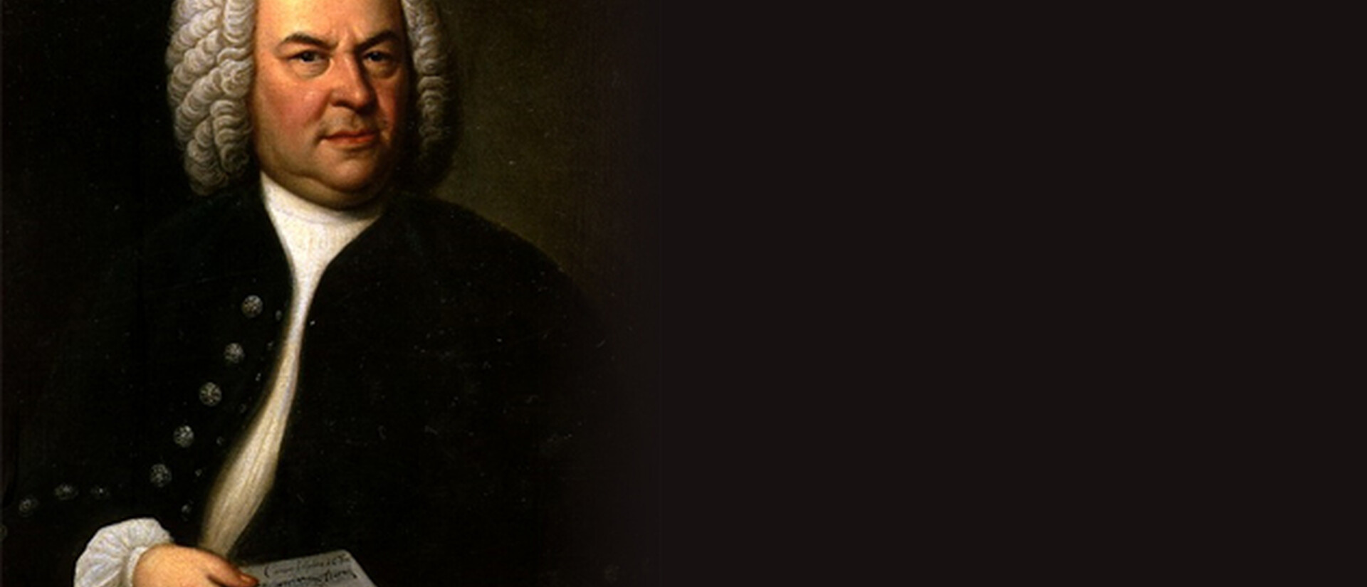 A picture of an older man with a white curled wig and an open jacket. He is holding a small piece of manuscript paper
