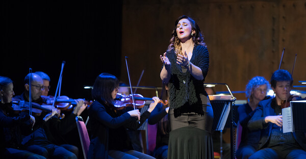 Opera singer in front of orchestra