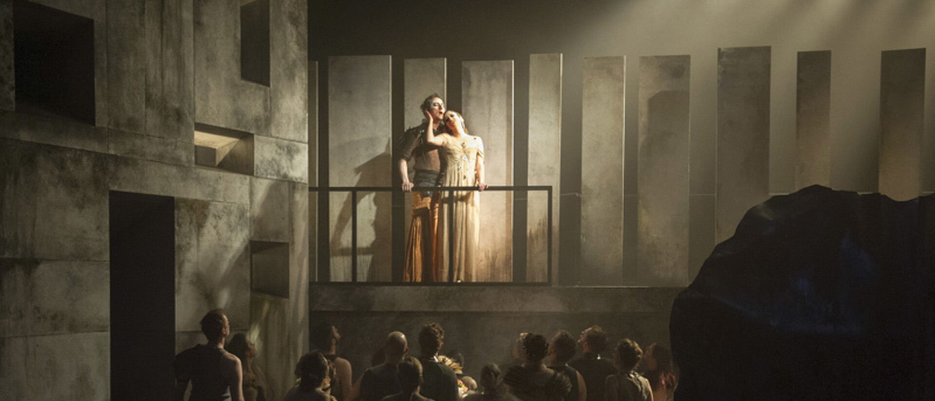Couple on a balcony overlooking crowd