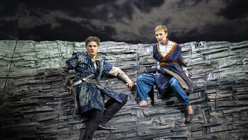 Two opera singers on a rocky, grey lancscape in ETO's 2018 Radamisto